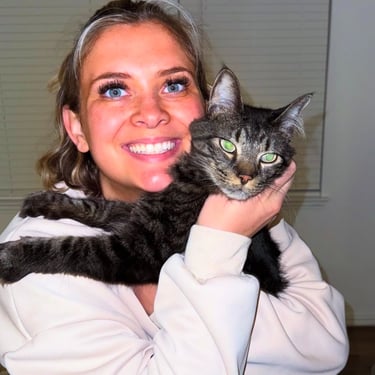 Sitter cuddling a cat